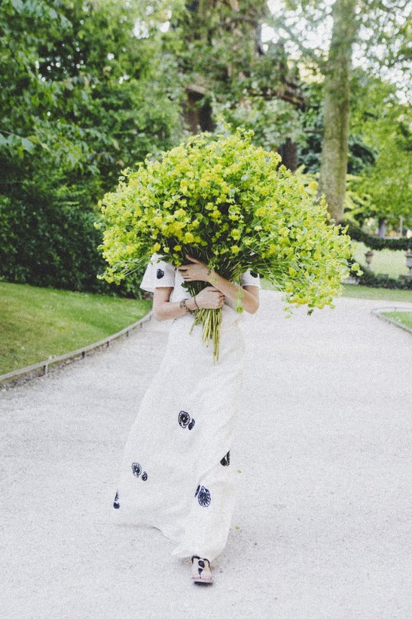 Wild Child is a photo of a girl in Jardin du Luxembourg in Paris with a beautiful bouquet of green blooms and is part of a limited edition series named Young Girl in Bloom by photographer Carla Coulson celebrating women loving and believing in themselves and building their self esteem by trusting their intuition.