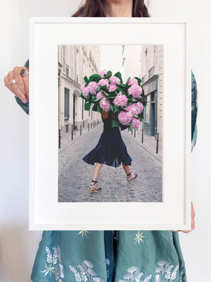 Free and Fearless is a photo of a girl in Paris in St Germain des Prés holding a giant bouquet of pink hydrangeas and is part of a limited edition series named Young Girl in Bloom by photographer Carla Coulson celebrating women loving and believing in themselves and building their self esteem by trusting their intuition.
